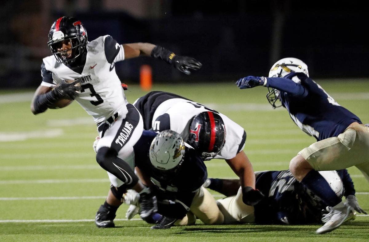 Trinity running back Gary Maddox (3) breaks out of the pack for yardage in the first half of a Class 6A D1 bi-district football game between Keller and Euless Trinity at Keller ISD Stadium in Keller, Texas, Friday, Nov. 11, 2022. Trinity led Keller by three at the half. Temperature at game time was 39 degrees. (Special to the Star-Telegram Bob Booth)