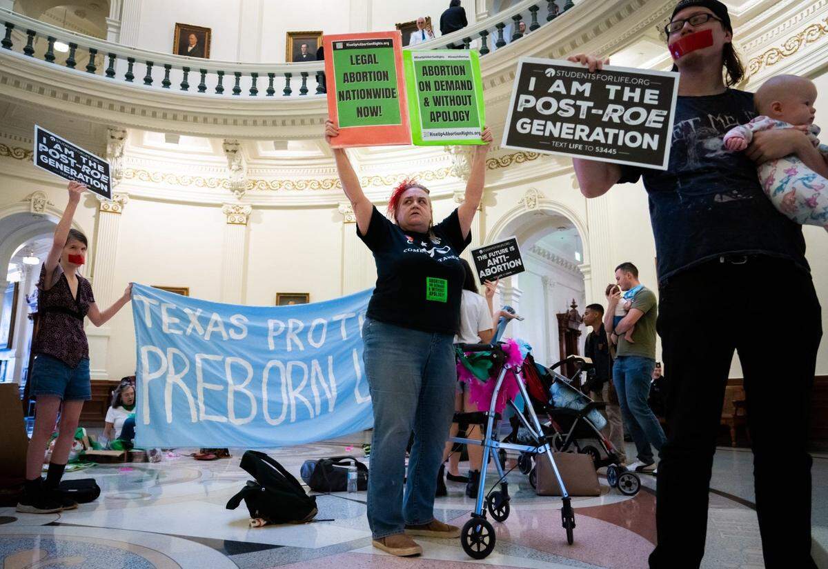 Betsy Riot, center, takes part in the International Women’s Day Sit-In for Abortion Rights in the Texas State Capitol Rotunda in March 2023. Both abortion rights and anti-abortion protesters were present on the rotunda.