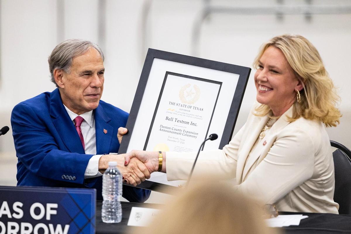 Governor Greg Abbott gives Lisa Atherton, the President of Bell Textron Inc., a certificate of recognition during the announcement that Bell Textron has chosen Fort Worth for major expansion to build V-280 Valor military aircraft Bell Manufacturing Technology Center in Fort Worth on Tuesday, Dec. 17, 2024.