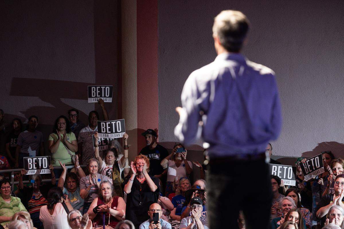Rally attendees hold signs in support of former U.S. Rep. Beto O’Rourke as he speaks during ‘The People vs. The Power Grab’ rally at the Ridglea Theater in Fort Worth on Saturday, Aug. 9, 2025.