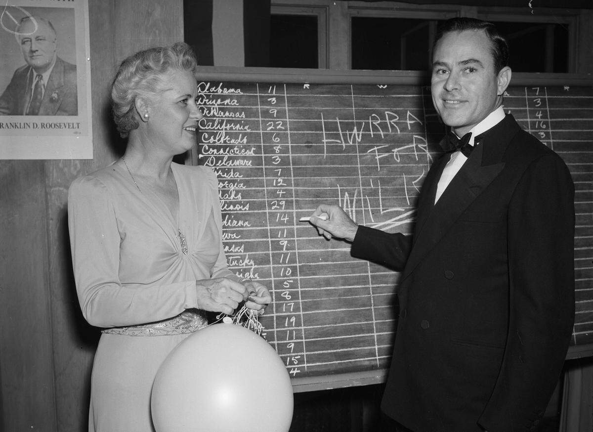 Nov. 5, 1940: Mr. and Mrs. Van Zandt Smith, hosting an election dinner party at River Crest Country Club, shown at the score board on which voting was recorded.