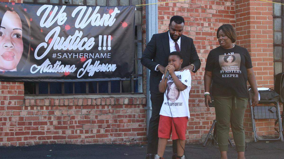 Attorney Lee Merritt stands with Atatiana Jefferson’s sister and nephew to thank people for attending Sunday’s community rally.