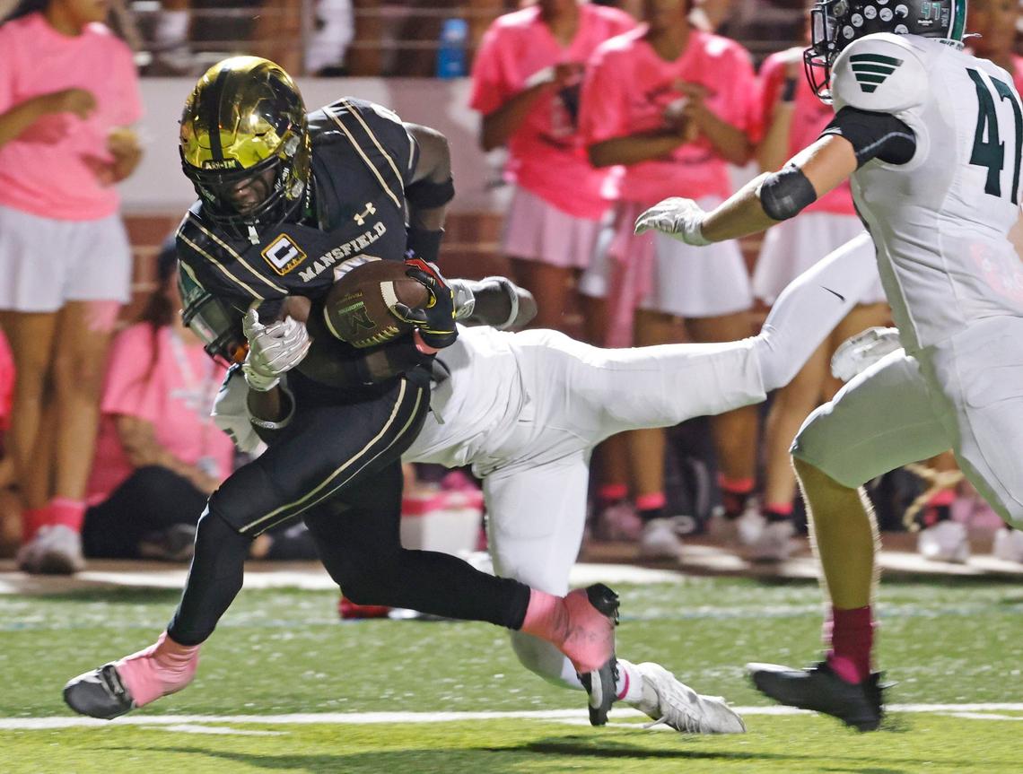Lake Ridge defensive back Cameron Wilson attempts to keep Mansfield wide receiver Jacobe Hayes (0) out of the end zone during a game Oct. 3, 2024, at Vernon Newsom Stadium in Mansfield.