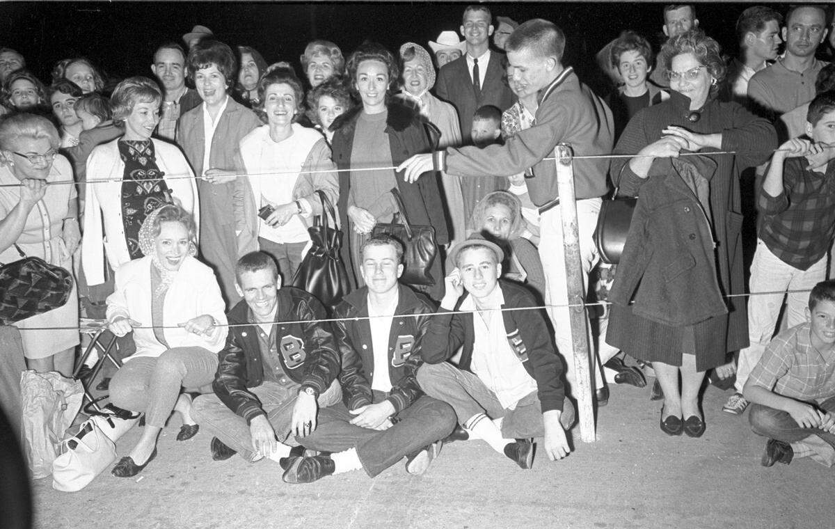 Crowds waiting at Carswell Air Force Base for arrival of President John F. Kennedy and his wife and Vice President Lyndon B. Johnson and his wife, Nov. 21, 1963.