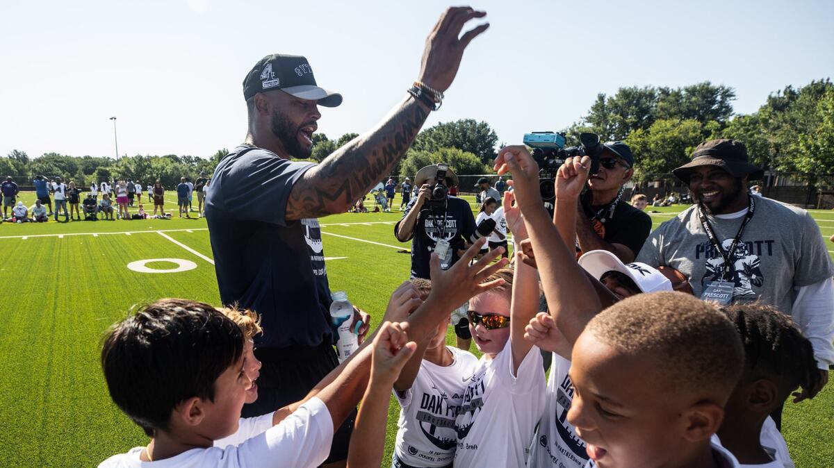 Cowboys quarterback Dak Prescott leads campers in a drill at the Tom Thumb & Albertsons Dak Prescott Football ProCamp in partnership with P&G at Carroll Senior High School on Tuesday.
