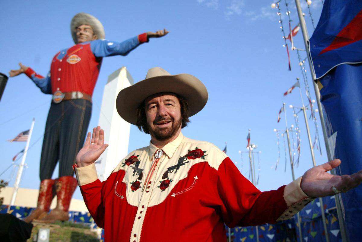 Sept. 30, 2005: Bill Bragg, a DFW airport screener, mimics Big Tex’s pose as he is the voice of Big Tex at the State Fair of Texas in Dallas.