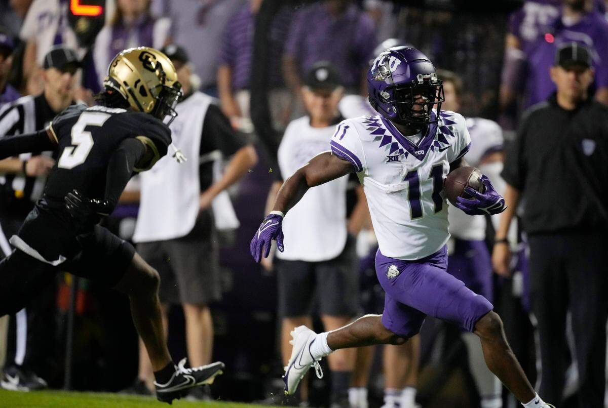 TCU wide receiver Derius Davis, right, runs for a touchdown after catching a pass with Colorado safety Tyrin Taylor in pursuit in the second half of an NCAA college football game Friday, Sept. 2, 2022, in Boulder, Colo. (AP Photo/David Zalubowski)
