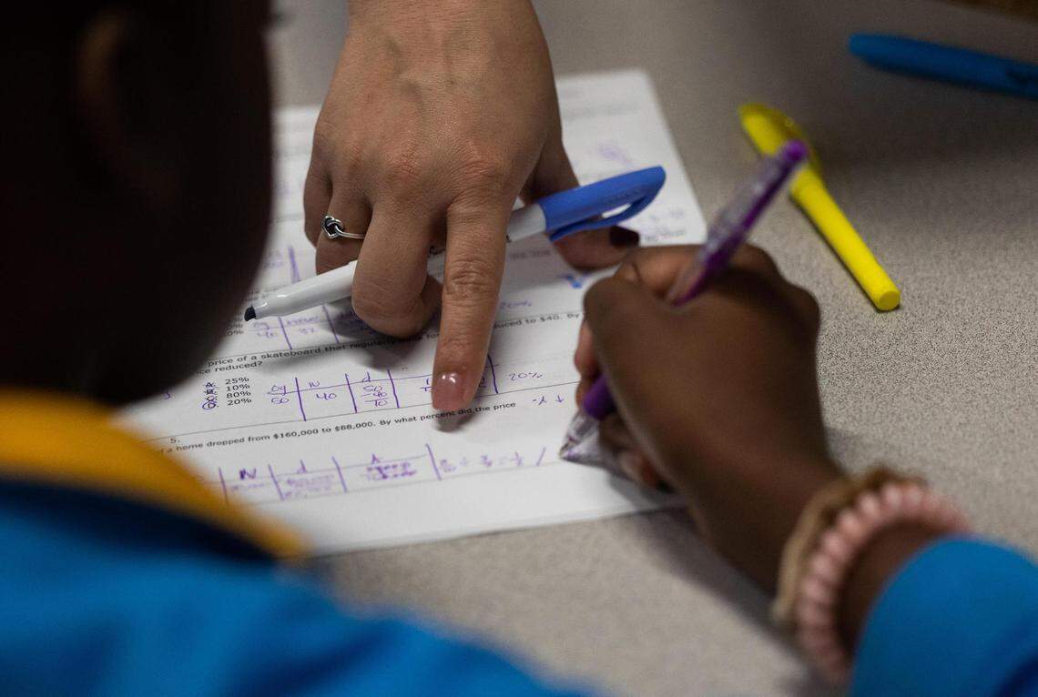 Teacher Allison Burrola checks students’ work during class at IDEA Rise charter school on Nov. 10, 2022, in Fort Worth.