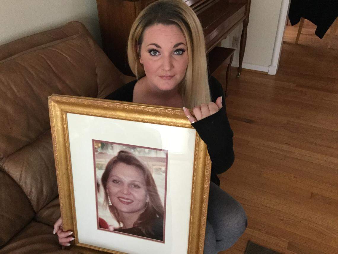 Bridget Johns Scott holds a photograph of her half-sister, Megan Johns. Bridget was only 9 when Megan was found fatally stabbed inside her Irving apartment on Oct. 5, 1994. Darryl Patrick Goggans, 61, was arrested Tuesday and charged with capital murder in Johns’ death.