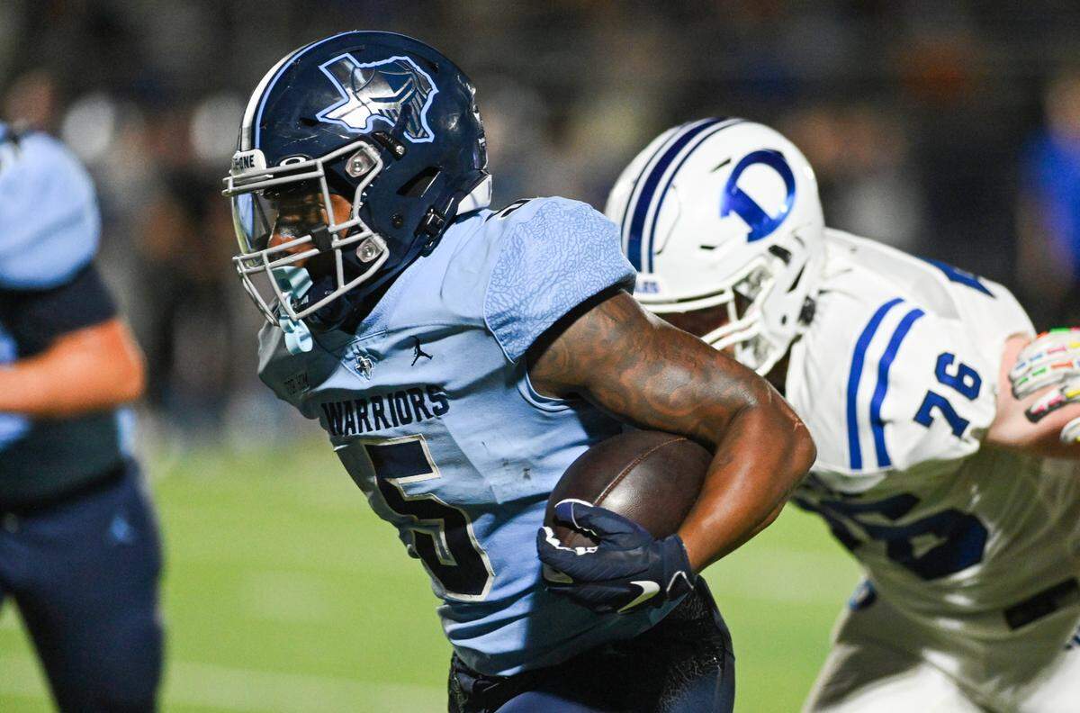 Liberty Christian running back Chase Garnett, #5, runs past defenders during a UIL football game against Decatur at Warrior Stadium in Argyle, Texas on Friday, Sept. 13, 2024. Garnett is in his senior season.