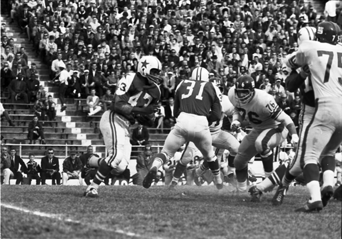 The Dallas Cowboys hosted the New York Giants on Dec. 1, 1963, just days after the assassination of President John F. Kennedy and subsequent fatal shooting of alleged assassin Lee Harvey Oswald. The New York press that came to Dallas for the game weighed on a city where Kennedy was killed. Here, Cowboy Don Perkins (#43) carries ball defended by Amos Marsh (#31).