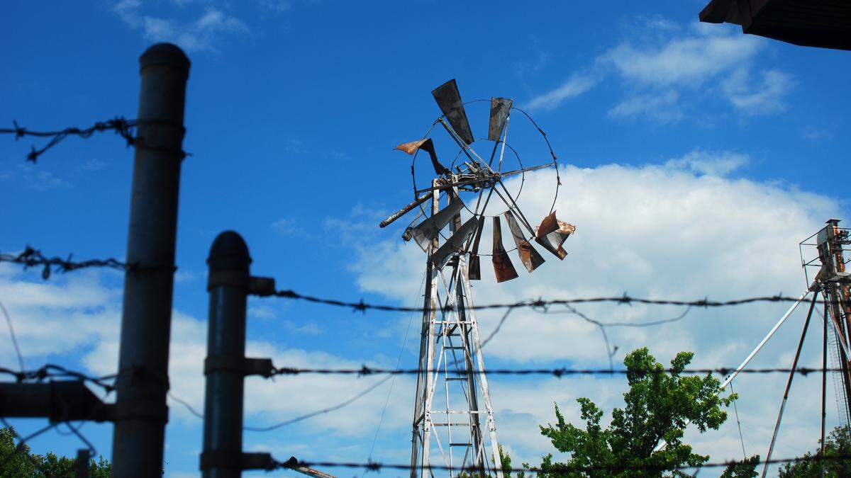 A dilapidated windmill, photographed on July 13, 2019, sits behind the Delta County Patterson Memorial Museum in Cooper, Texas. The museum occupies the site of the former Cooper Rail Depot, one of the only remaining stops along the defunct Texas Midland Railroad, abandoned in the 1970s.