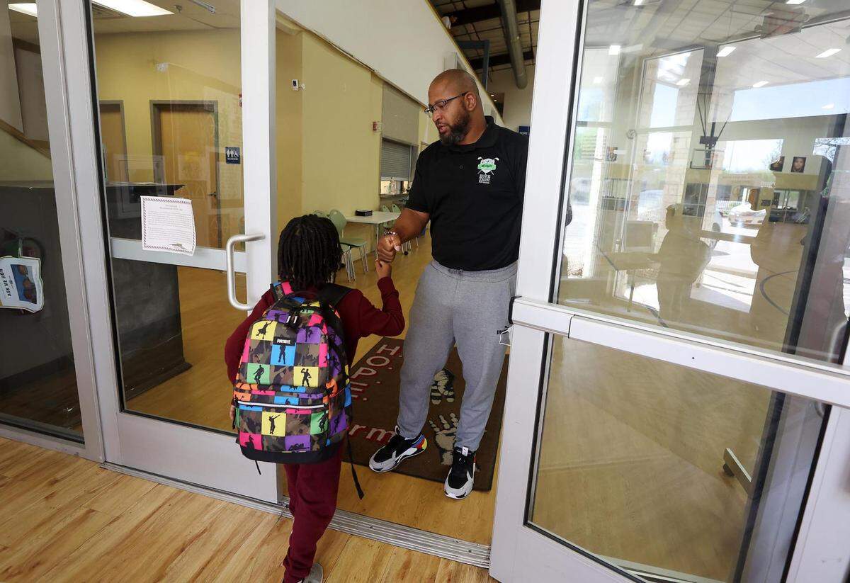 Mario Choice fist bumps young men as they arrive after school to Hope Farm on Wednesday, April 13, 2022, in Fort Worth. Hope Farm is a mentor program that focuses providing young at-risk boys with positive male role models.