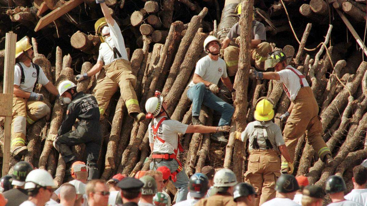 Emergency personnel dig throughout the fallen logs for the bonfire at Texas A&M in College Station that killed 12 students. Shortly before 3 a.m., the log pile shifted as dozens of students worked all night atop stacks of wood on the A&M polo fields. The top logs crashed to the ground.