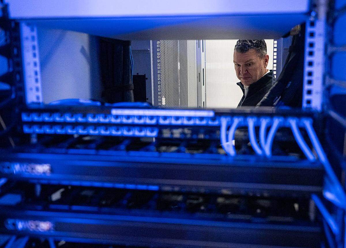 Chris Sharp, Chief Technology Officer of Digital Realty, looks at active servers in the Digital Realty Innovation Lab (DRIL) data center in Ashburn, Virginia on November 12, 2025. Data centers are the physical infrastructure that make our digital lives possible, yet most people have never seen one up close or understand how they operate. Roughly 12,000 data centers are in operation in the world, with about half in the US, according to Cloudscene, a data center directory. (Photo by ANDREW CABALLERO-REYNOLDS / AFP via Getty Images)