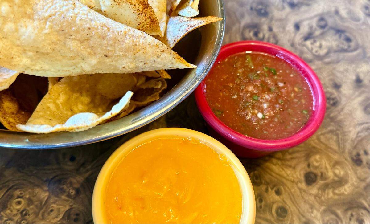 Chile powder-dusted chips with the restaurant’s signature cheese sauce and salsa at Campo Verde in Dalworthington Gardens Oct. 18, 2024.