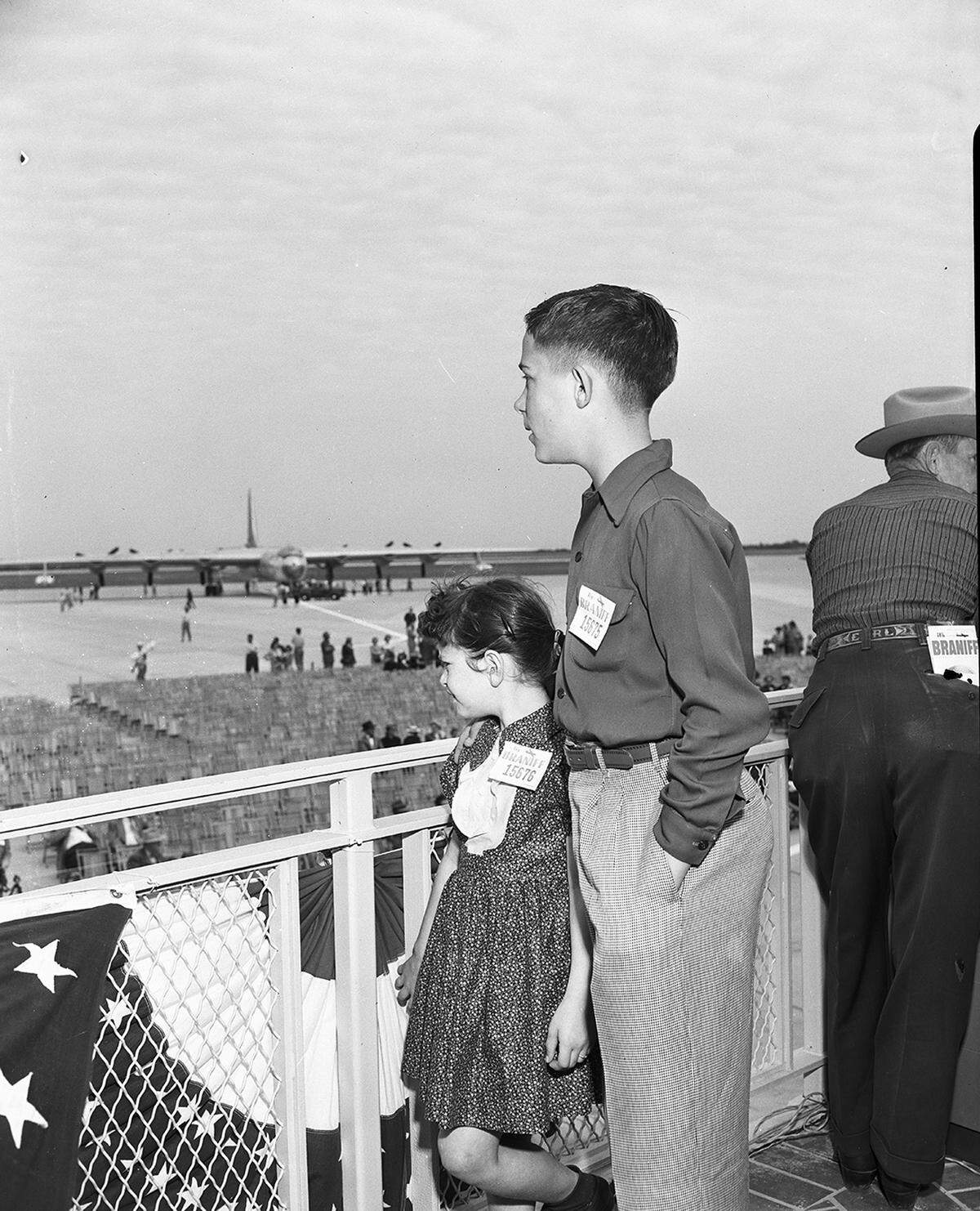  There is an unidentified man standing to the right of the children.
