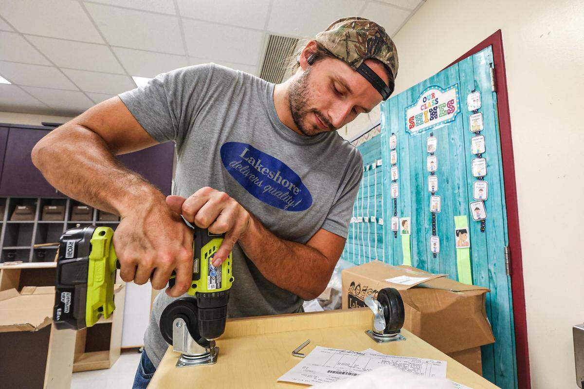 Kevin Hambleton of Lakeshore Learning Materials assembles a cabinet for a pre-kindergarten classroom at M.H. Moore Elementary in Fort Worth on Friday, July 28, 2023.