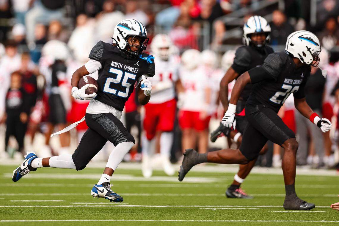 North Crowley punt returner Braylen Cunningham (25) runs with the ball with teammates blocking downfield in a Class 6A Division I regional playoff against Coppell on Saturday, Nov. 29, 2025, at Midlothian ISD Stadium in Midlothian.