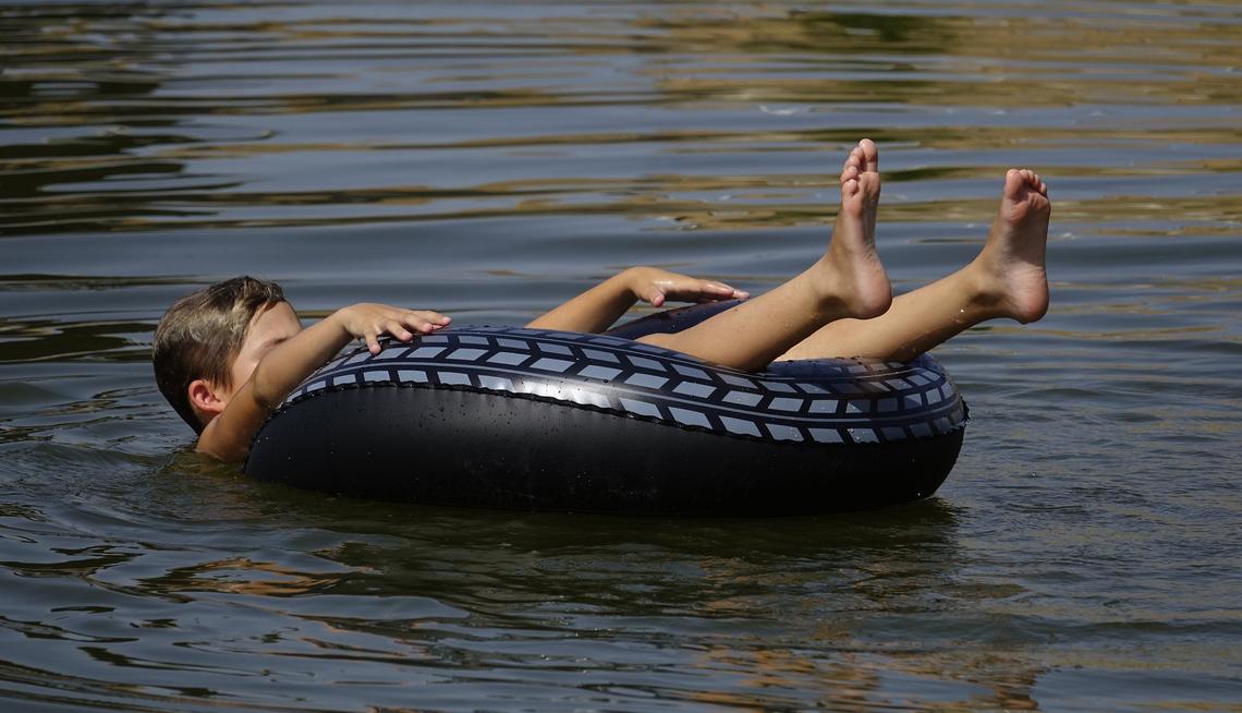 Dallas Ryan plays in the Trinity River at Panther Island Thursday afternoon. A new record of 108 degrees was set at Dallas-Fort Worth International Airport on Thursday.
