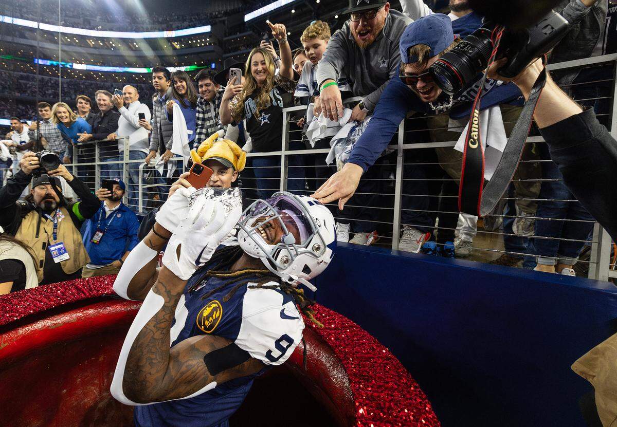 Dallas Cowboys wide receiver KaVontae Turpin pulls a turkey leg out of the Salvation Army Kettle after scoring a touchdown against the Washington Commanders on Thursday, November 23, 2023, at AT&T Stadium in Arlington.