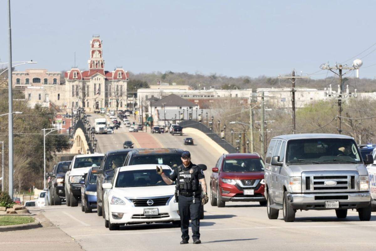 Police officers direct traffic as stoplights are out after severe thunderstorms in Weatherford on Friday.
