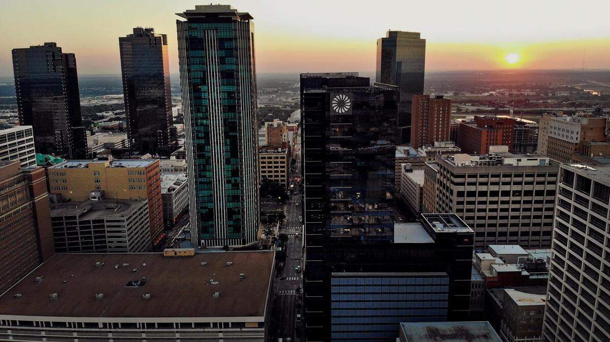 The sun rises behind downtown Fort Worth’s skyline on Friday, September 9, 2022.