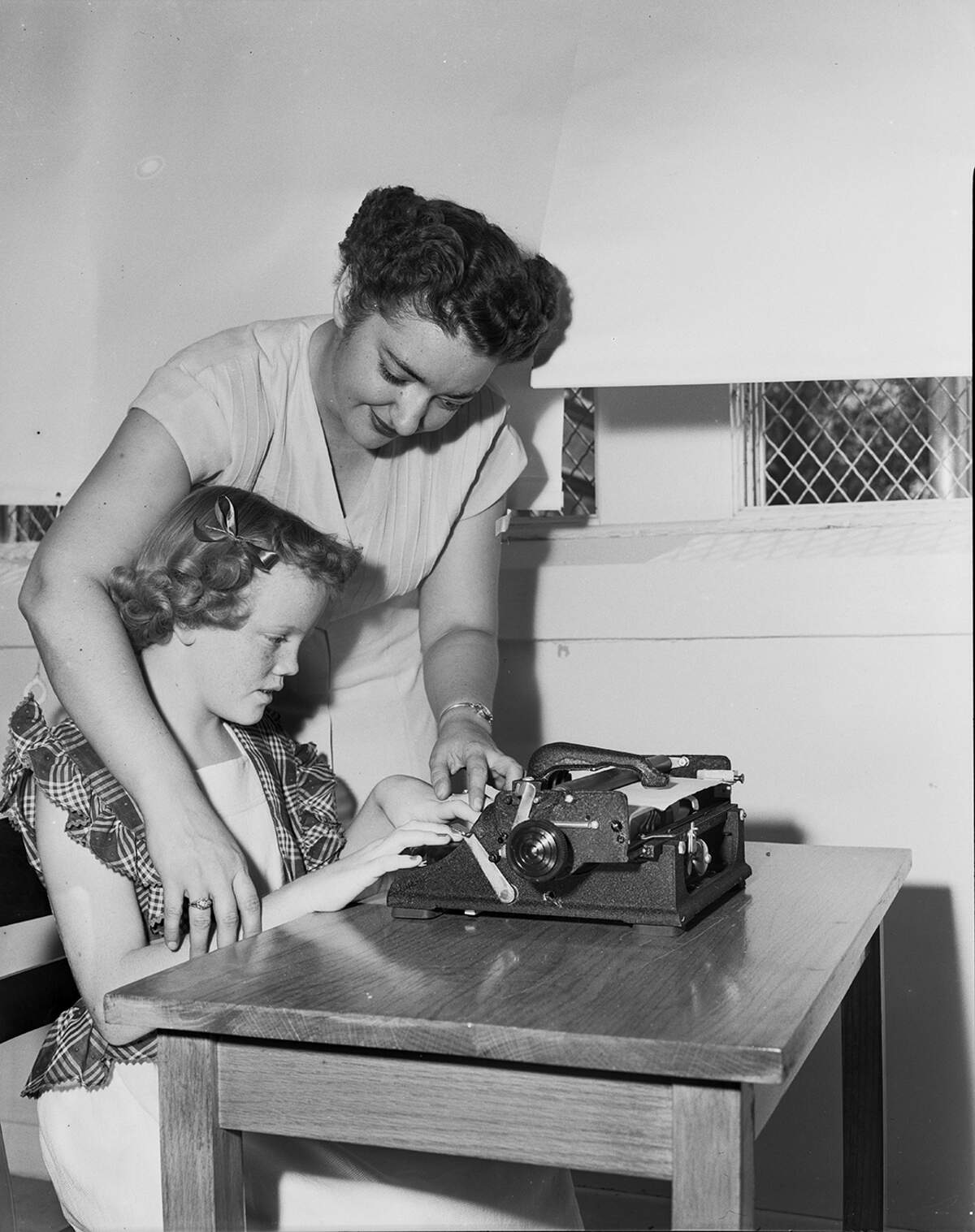 Aug. 31, 1951: Kathleen Cother, who is blind and the daughter of Mr. and Mrs. L.H. Cother, tried out a Braille typewriter on her first day at the Fort Worth School for Exceptional Children. Her teacher, Miss Georgine Cuchener, uses the new Braille equipment in teaching the blind children of Fort Worth.