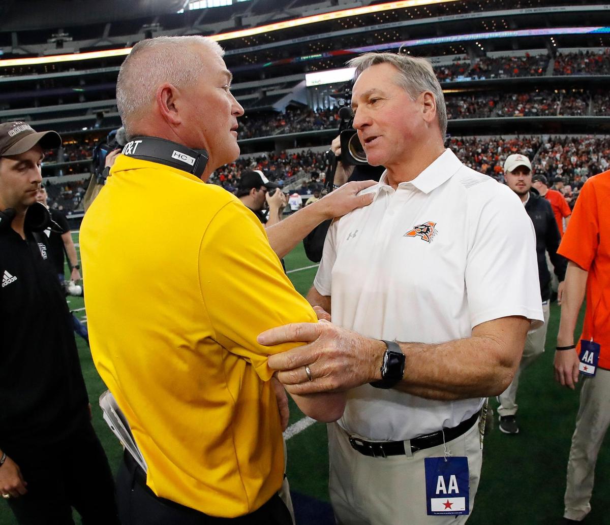 College Station head coach Stoney Pryor congratulates Aledo head coach Tim Buchanan after the UIL Class 5A D1 state championship football game at AT&T Stadium in Arlington, Texas, Saturday, Dec. 16, 2022. The Aledo Bearcats defeated The College Station Cougars 52-14. (Star-Telegram Bob Booth)