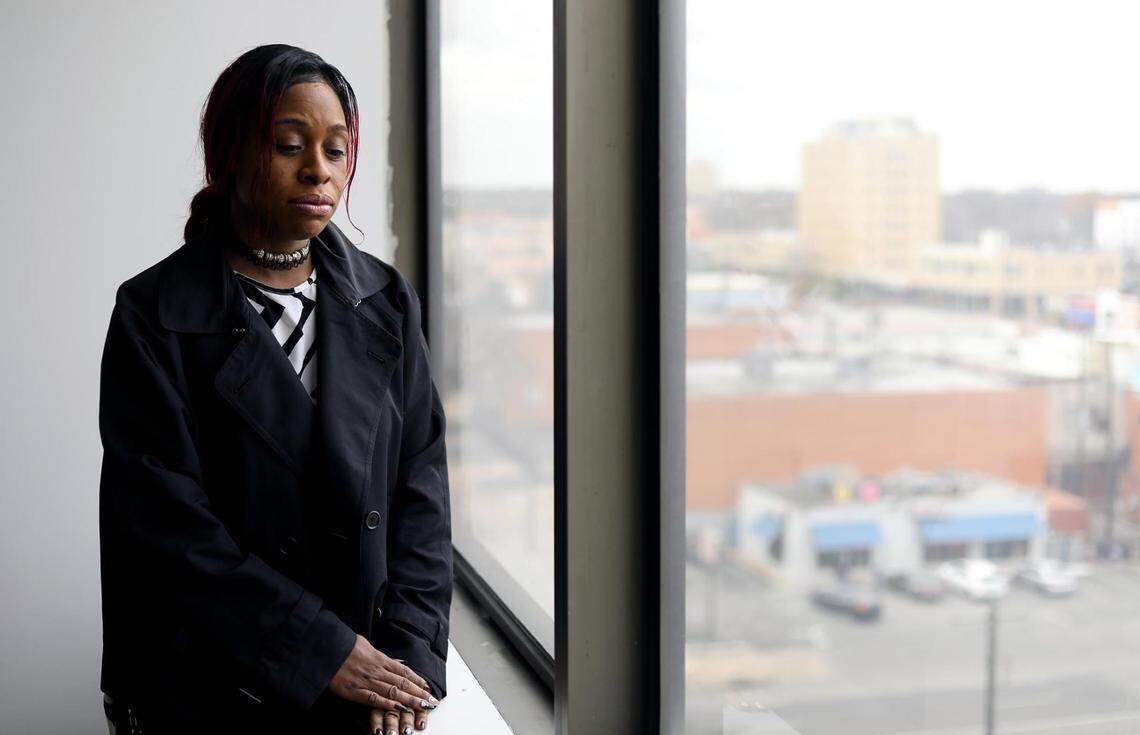 Robert Miller's wife, Shanelle Jenkins, stands inside of her attorney's office.