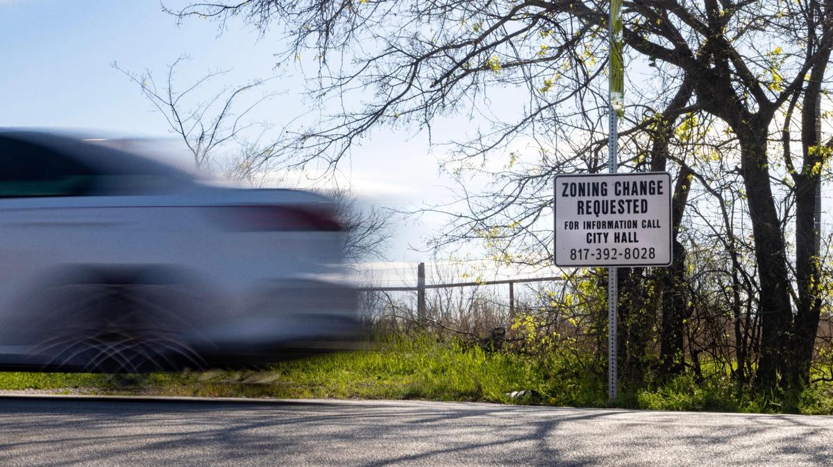 Cars pass by a lot for sale on Wednesday
