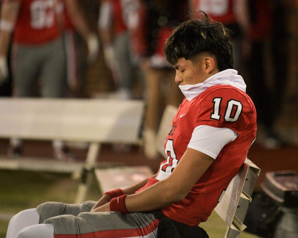 Argyle kicker Anthony Ruvalcaba (10) sits alone on a bench after a losing to South Oak Cliff in a Class 5A Division II state semifinal on Friday, Dec. 13, 2024 at Gerald J. Ford Stadium in University Park, Texas.