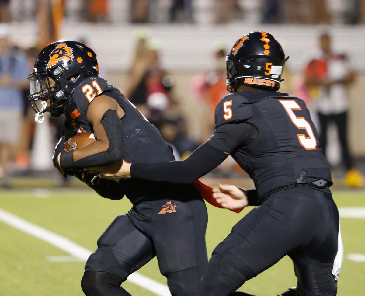 Aledo quarterback Gavin Beard (5) hands off to running back Kaden Winkfield (21) during the fourth quarter of a UIL football game at Buchanan Stadium in Aledo Texas, Friday, Oct. 04, 2024.