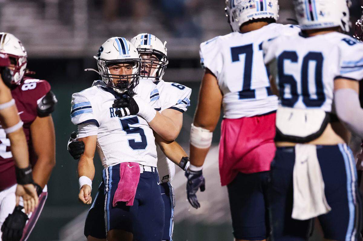L.D. Bell quarterback Braylon Harris celebrates with his teammate after scoring a touchdown during a district game between Keller Central and L.D. Bell at Keller ISD Stadium in Keller, Texas on October 16, 2025.