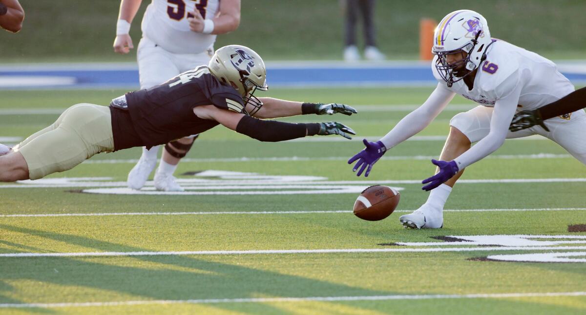 Birdville’s Parker Green and Grandbury’s Jonathan McCandless dive for a fumble during their game Thursday night at Birdville Athletic Center. Green recovered the ball. JOHN ROWLAND