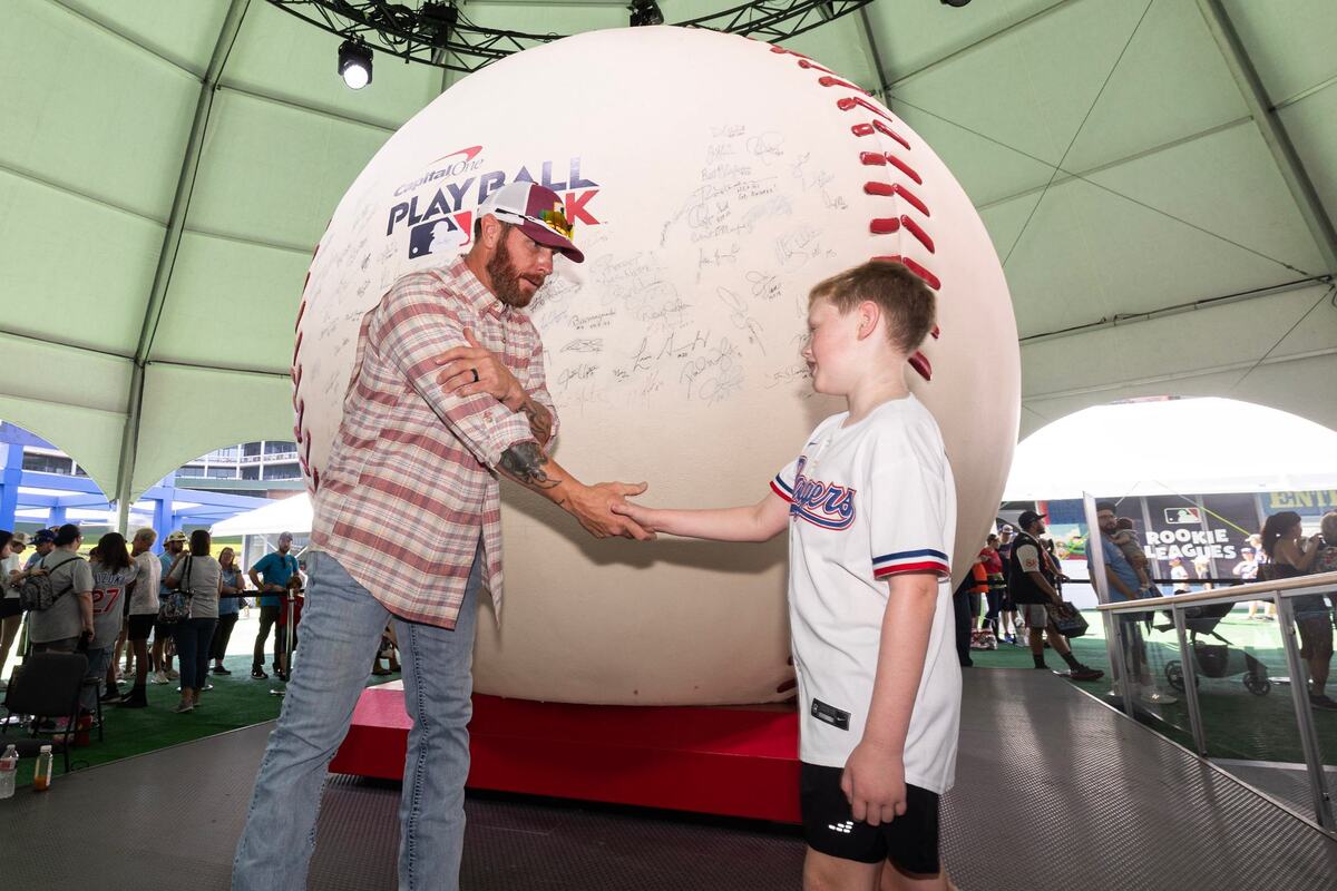 Legendary Texas Rangers outfielder Josh Hamilton greets Liam Smith, 9, during a meet and greet for the first day of the 2024 MLB All-Star Village at Choctaw Stadium in Arlington on Saturday, July 13, 2024.