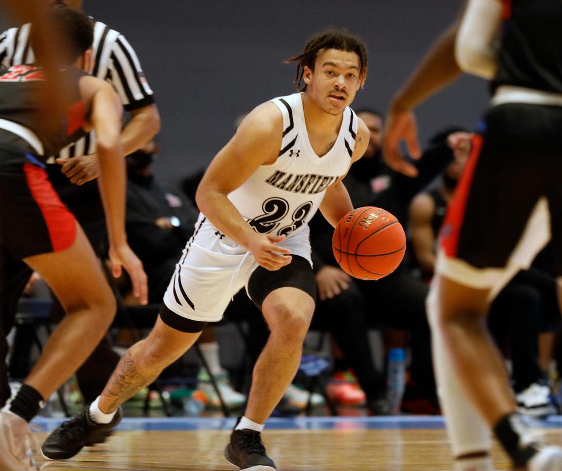 Mansfield guard Donerio Davenport (23) drives through the middle during the second half of a 6A Region 1 quarterfinal basketball game at Arlington ISD Athletics Complex in Arlington, Texas, Saturday, Feb. 27, 2021. Duncanville defeated Mansfield 73-53. (Special to the Star-Telegram Bob Booth)