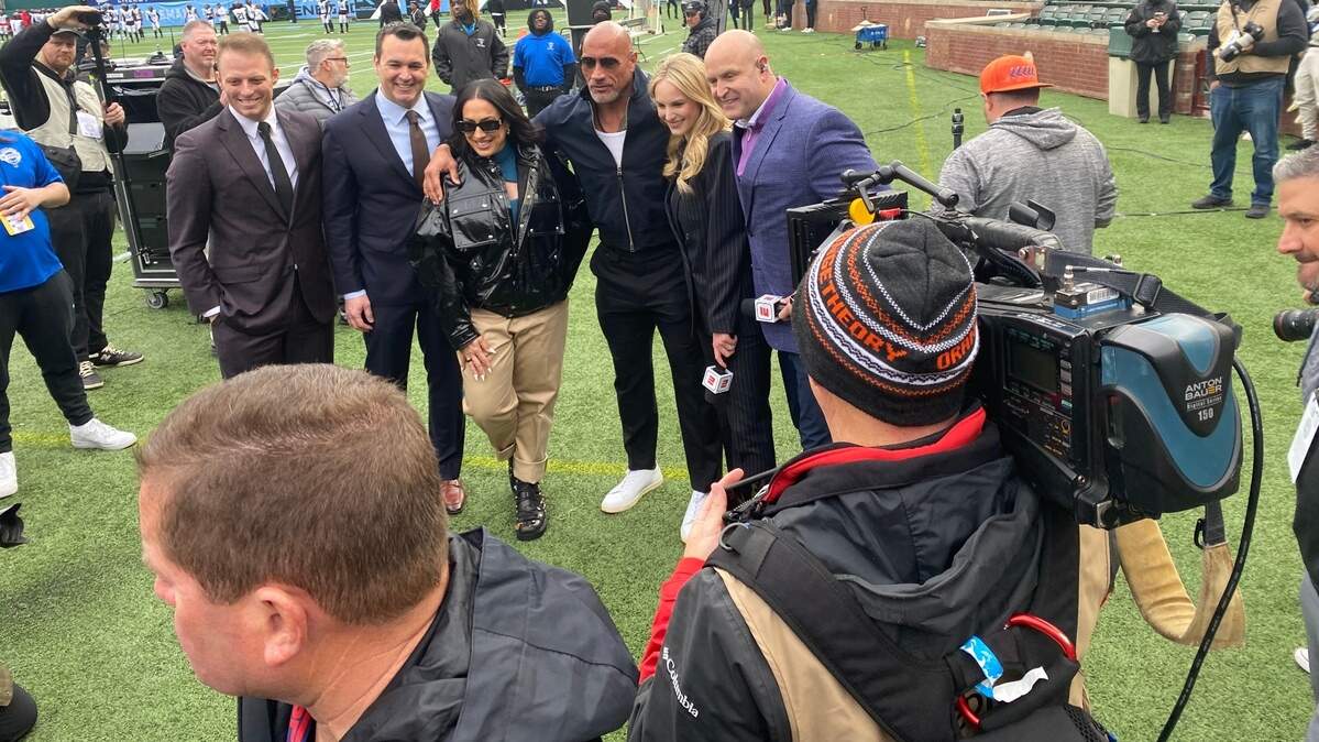 Dwayne Johnson and Dany Garcia pose at the XFL season opener