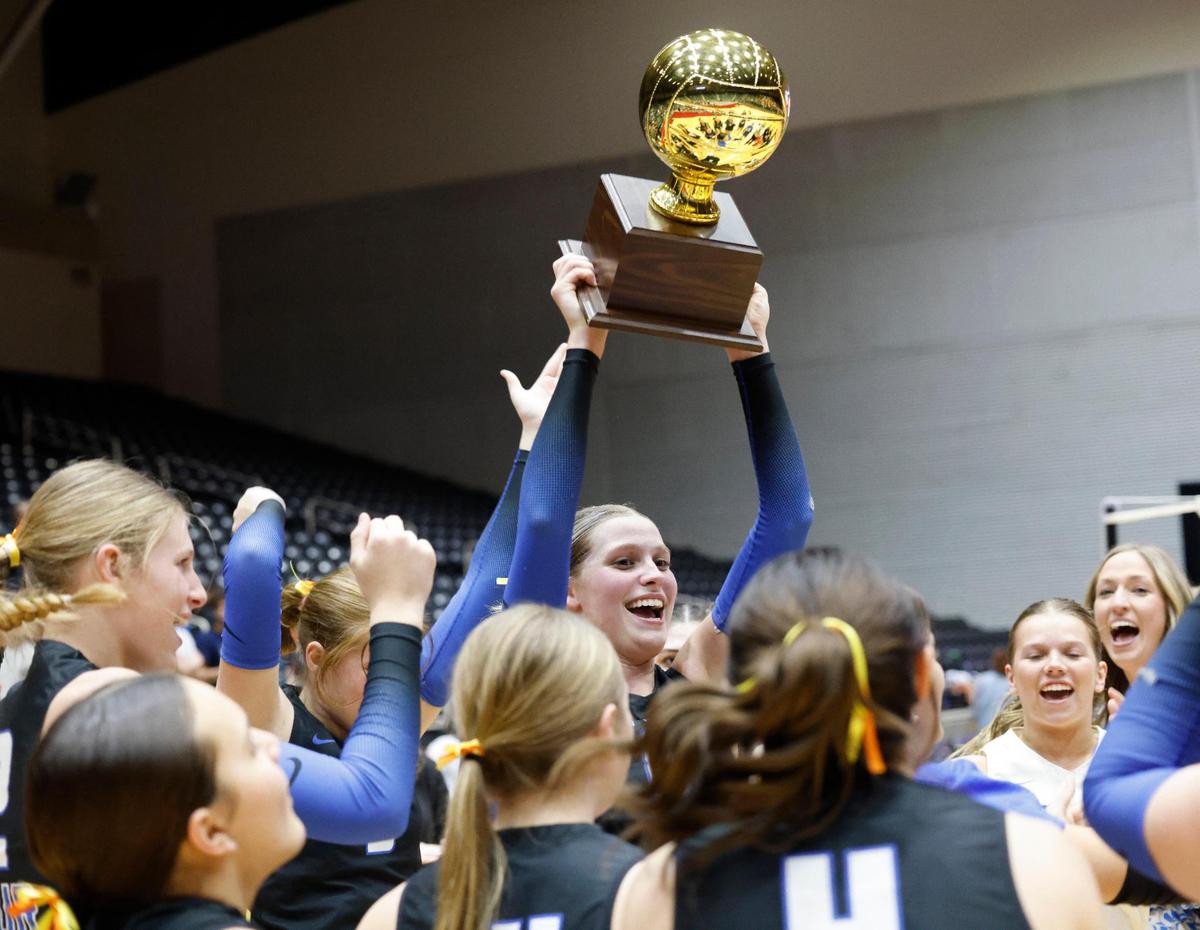 Decatur’s Lilly Lowery (8) displays the state semifinal trophy after advancing to state for UIL 4A D1 state championship volleyball match at Curtis Culwell Center in Garland Texas, Tuesday, Nov. 19, 2024.