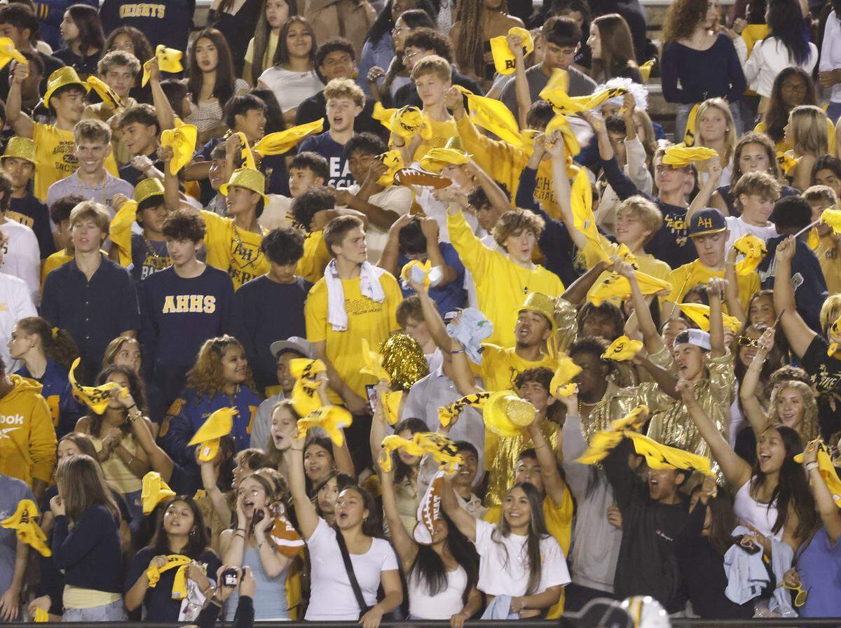 Yellow Jackets fans celebrate a score during the first half of a UIL football game between Arlington Heights and Paschal at Farrington Field in Fort Worth, Texas, Friday Nov. 07, 2025.
