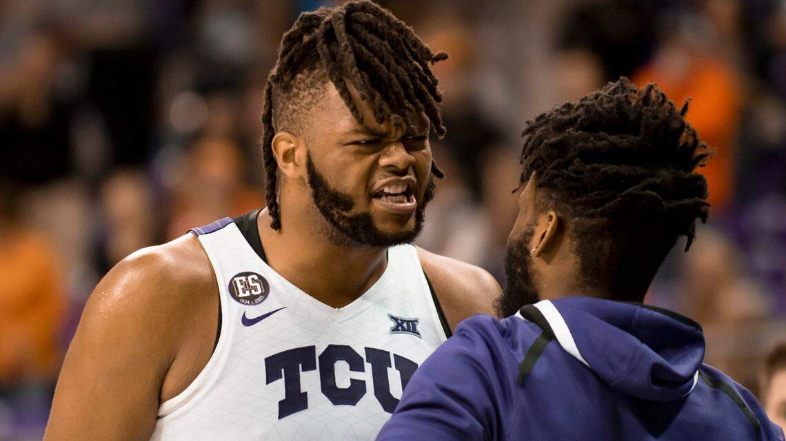 TCU center Eddie Lampkin Jr. (4) celebrates with TCU guard Mike Miles (1) after hitting two free throws in the second half of an NCAA college basketball game against Oklahoma State in Fort Worth, Texas, Tuesday, Feb. 8, 2022. With Lampkin and Miles returning TCU will start the season as a Top 15 team. (AP Photo/Emil Lippe)