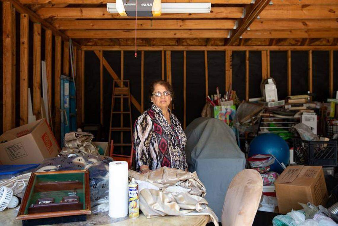 Shammi Bajaj stands in her garage where salvaged belongings from Hurricane Harvey remain to be sorted in Houston, Texas.