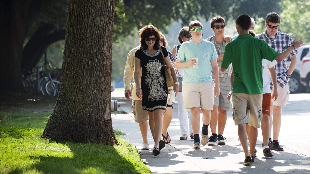 An Eagle Ambassador guides a group of prospective students and parents on a campus tour, August 4, 2014. (Ahna Hubnik / UNT)