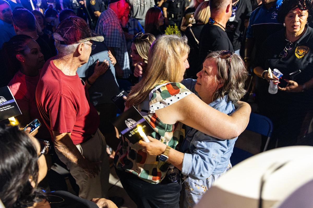 Chris Howard hugs her friend and coworker Lisa Randolph, the wife of the late Fort Worth Police Department Sgt. Billy Randolph, during his honorary vigil at the Fort Worth PD South Division headquarters in Fort Worth on Wednesday, Aug. 14, 2024. Sgt. Randolph was struck by a vehicle while working a crash scene on the exit ramp of IH-35W near Sycamore School Road Monday morning.