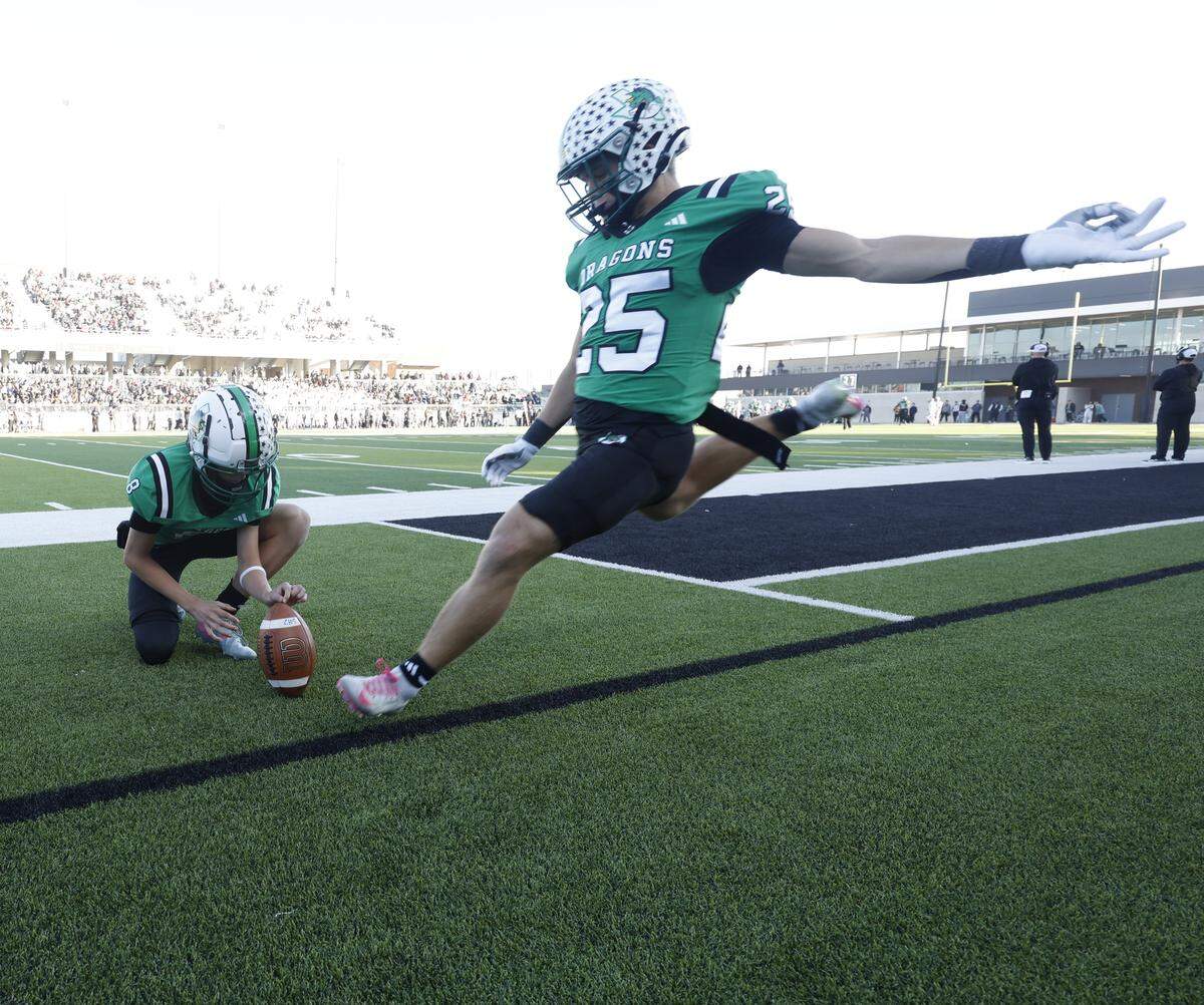 Southlake Carroll punter Zac Hays (8) holds for kicker Gavin Strange (25) during warmups against Denton Guyer during the second half of a UIL Class 6A Division II Quarterfinal on Saturday Dec. 06, 2025 at Crowley ISD Multi-Purpose Stadium in Fort Worth, Texas.