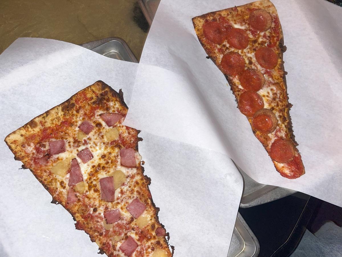 Tulane’s kitchen opens at 6 p.m. daily. On the left is their $8 Hawaiian slice and on the right is their $5 Pepperoni slice.