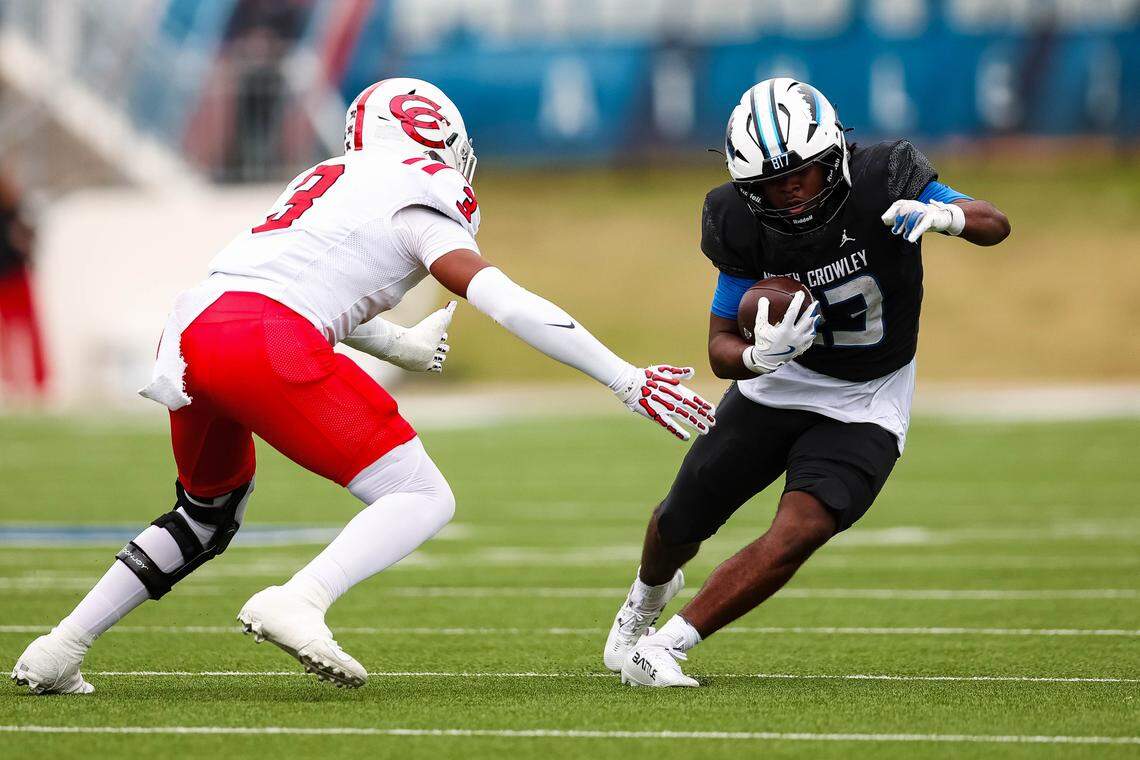 North Crowley running back Kiante Ingram (23) run away from lunging Coppell defensive lineman Braylon Powell (3) in a Class 6A Division I regional playoff Saturday at Midlothian ISD Stadium in Midlothian.