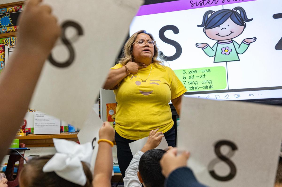 Kindergarten teacher Luz Botello teaches the pronunciations of letters to her class at Annie Webb Blanton Elementary School in Dallas on Tuesday, Oct. 22.