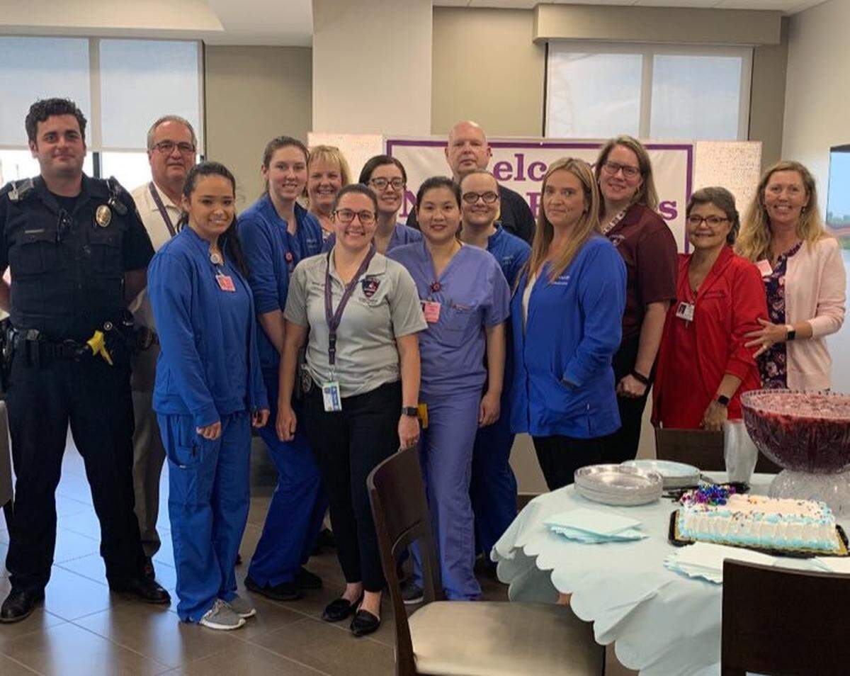 Arlington police officers and Medical City Arlington staff pose with baby “Jason,” who was found inside of a suitcase near a dumpster nearly two weeks ago. Officers gave him the unofficial name Jason, police said, and he’s been doing great.