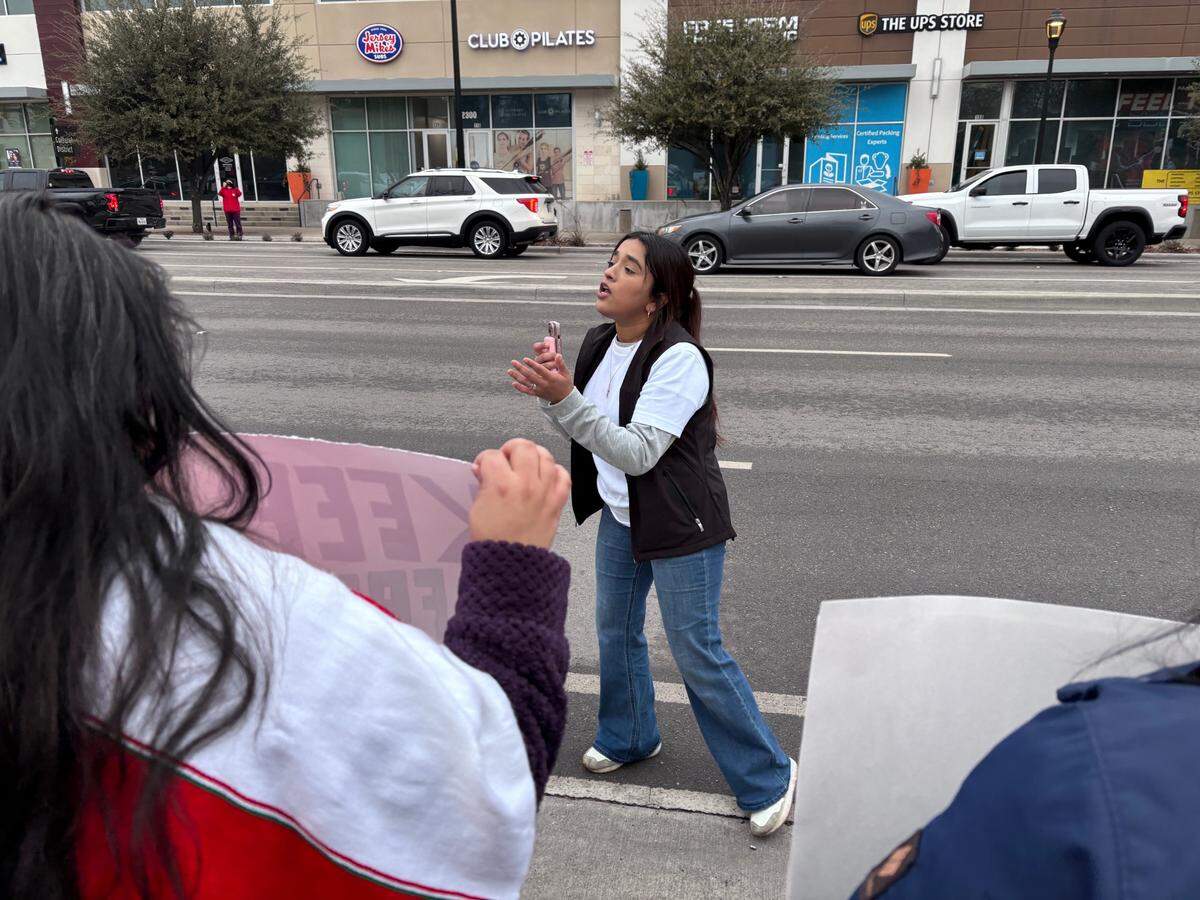 Fort Worth resident Marie Esquivel instructs protesters to remain on the sidewalk during a demonstration against deportations an family separation in Fort Worth on Sunday, Jan. 26, 2025.